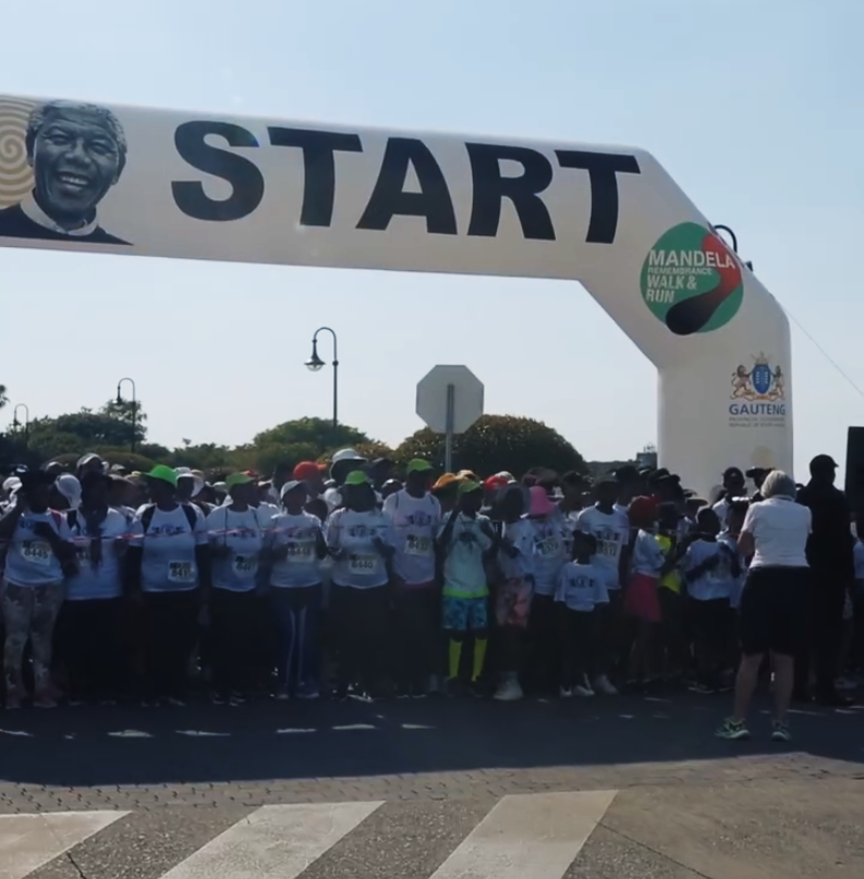 Crowd participating in Mandela Remembrance Walk & Run 2025 at Union Buildings